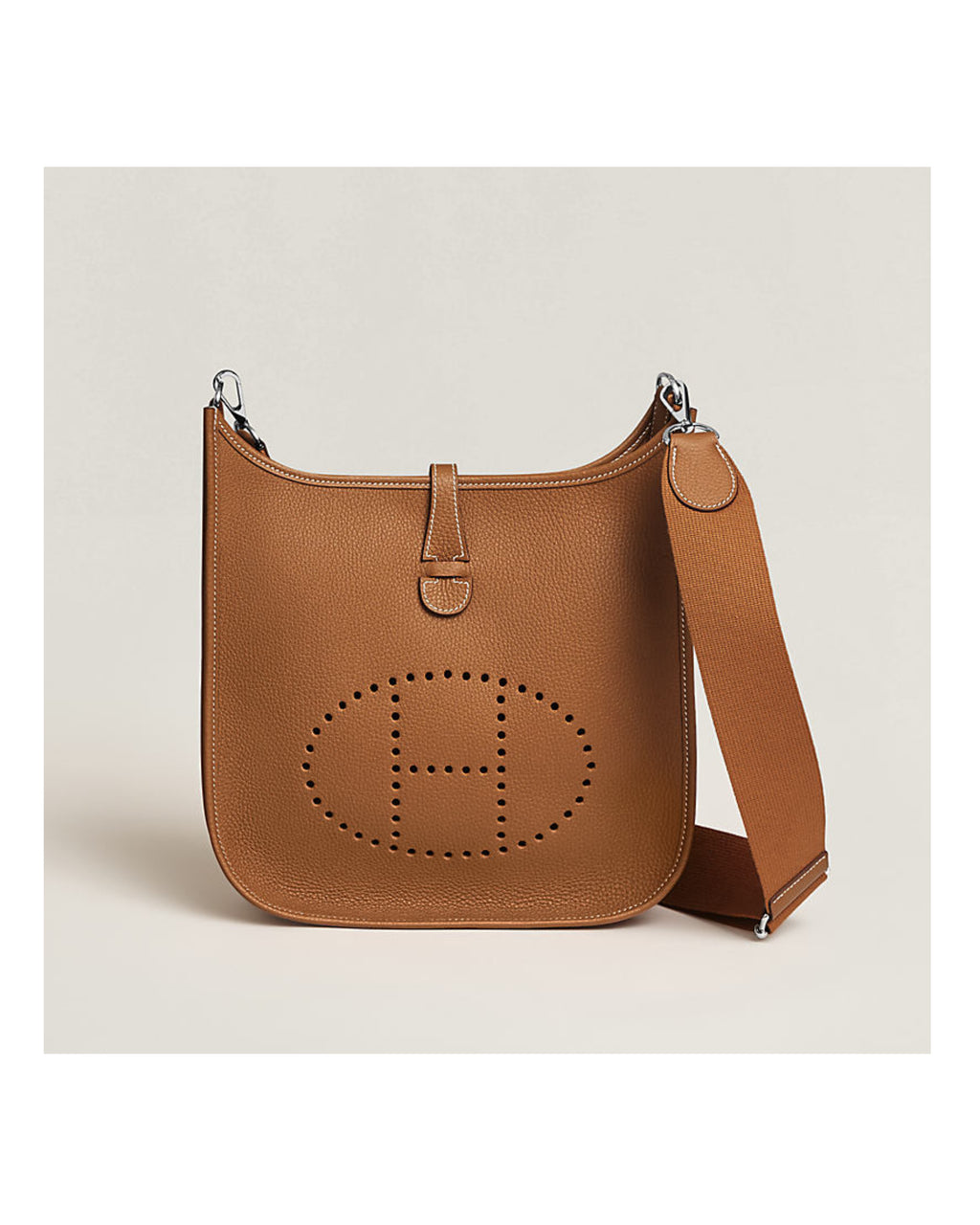 Brown leather handbag with a visible brand logo on a beige background