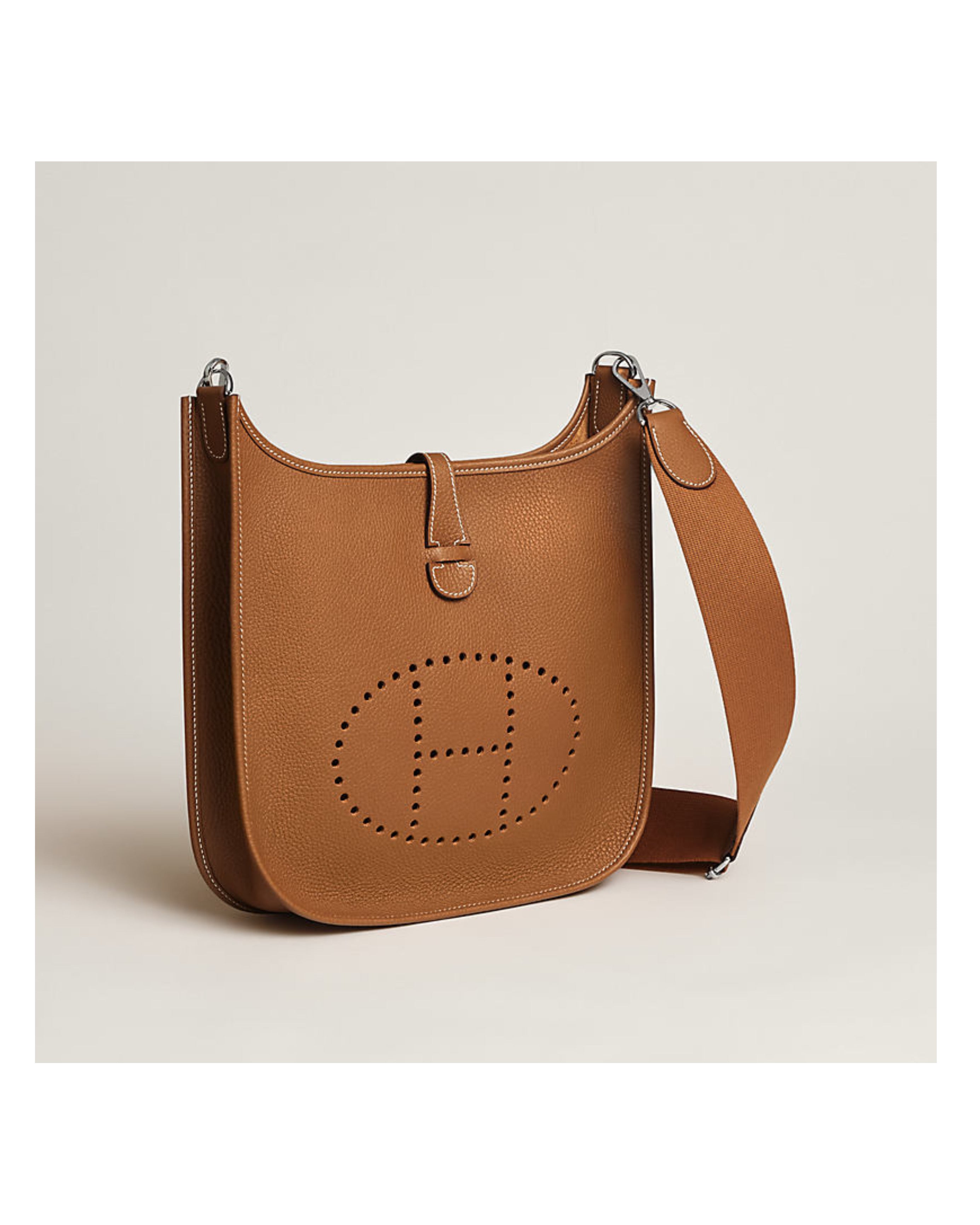 Brown leather handbag with a visible brand logo on a beige background