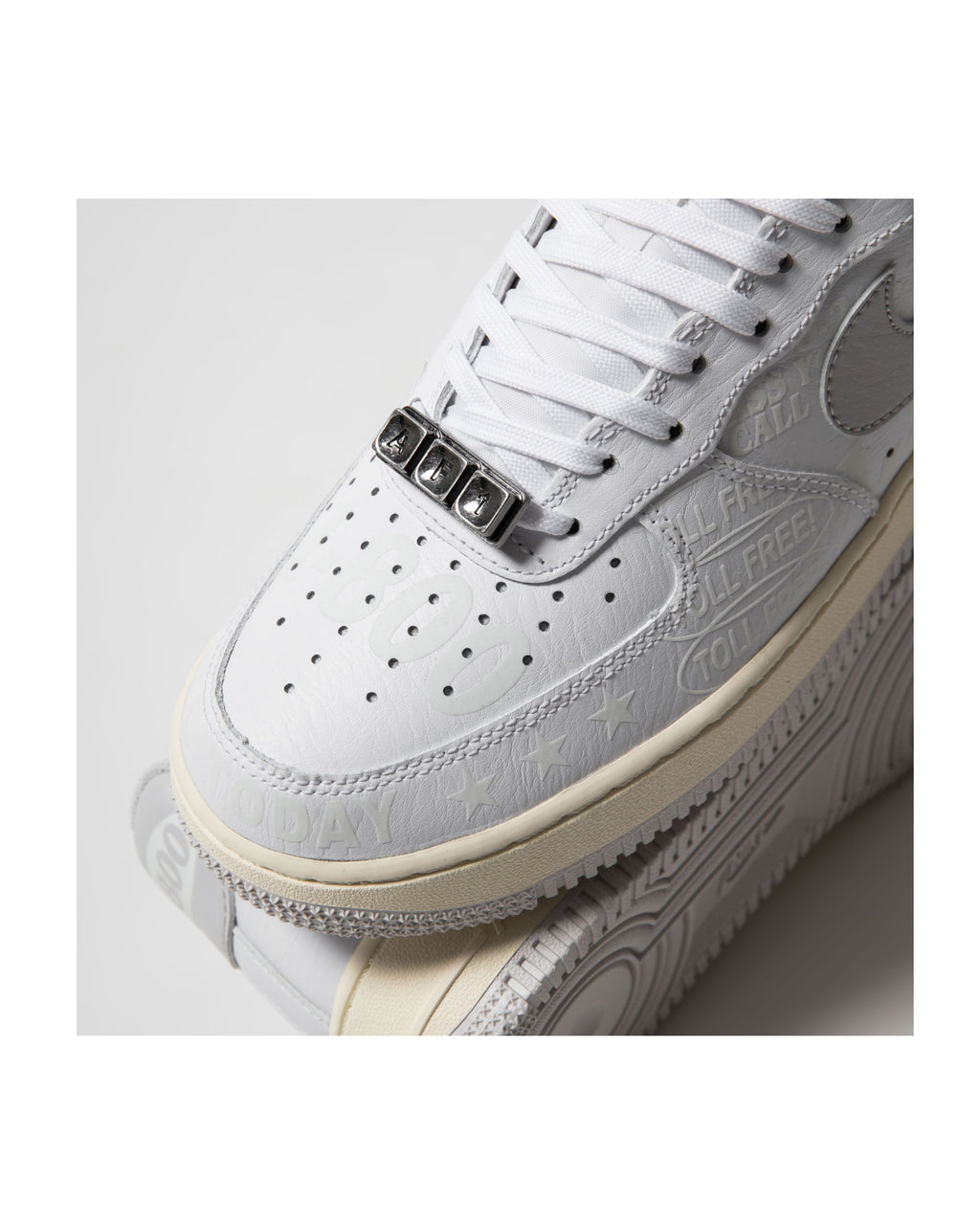 White sneaker with detailed design on a light gray background